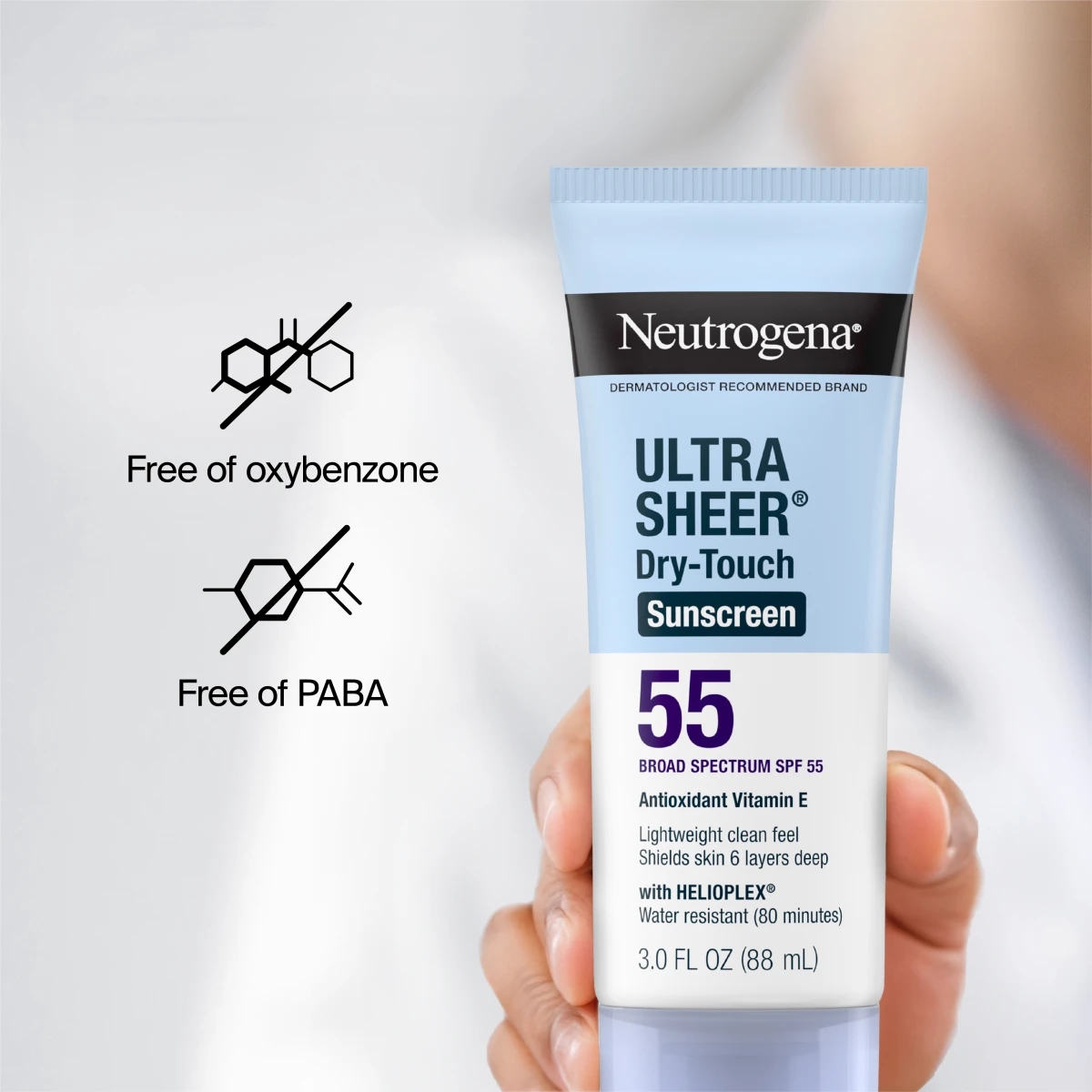 A hand holding the tube, with icons showing it is free of oxybenzone and PABA