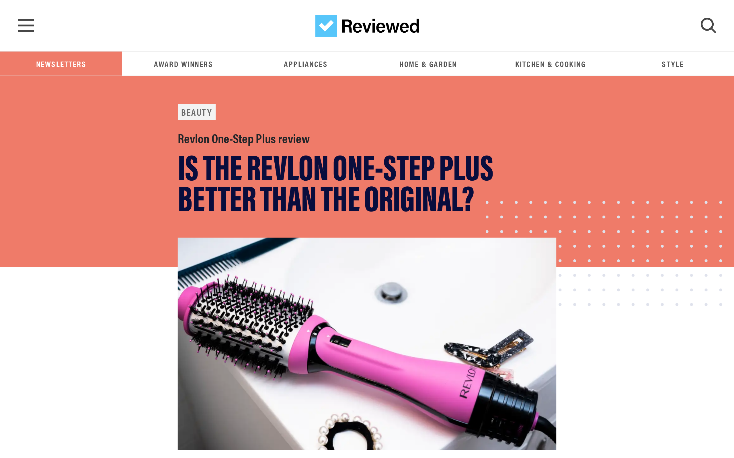 A dryer brush lying on a bathroom counter with hair accessories, from Reviewed's test of the PLUS