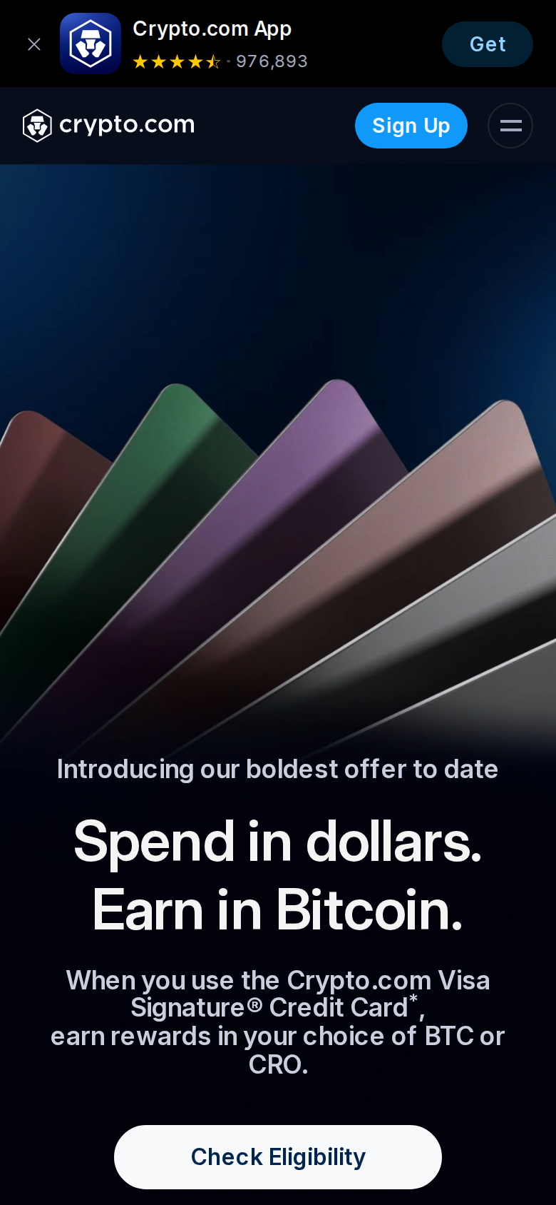 Crypto.com Visa Signature Credit Card page on a phone screen, headline 'Spend in dollars. Earn in Bitcoin.'