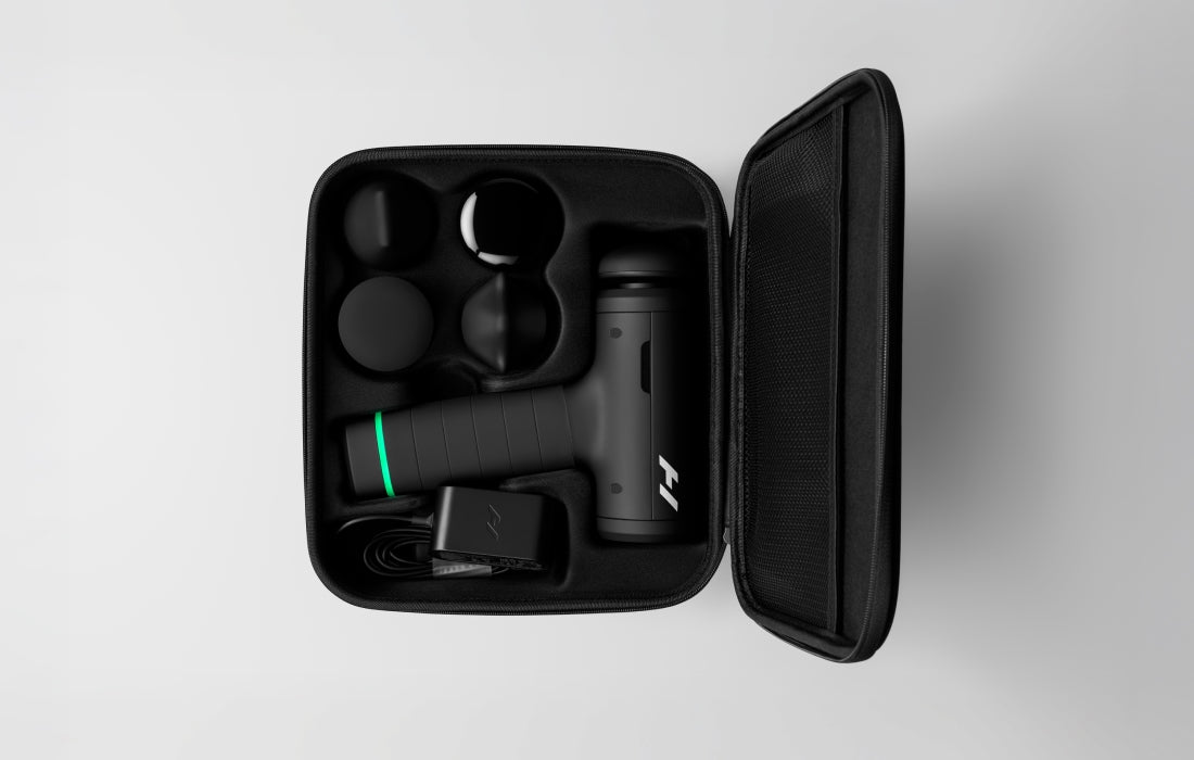Hypervolt 3 Pro open in its carry case with the attachments held in cut-outs