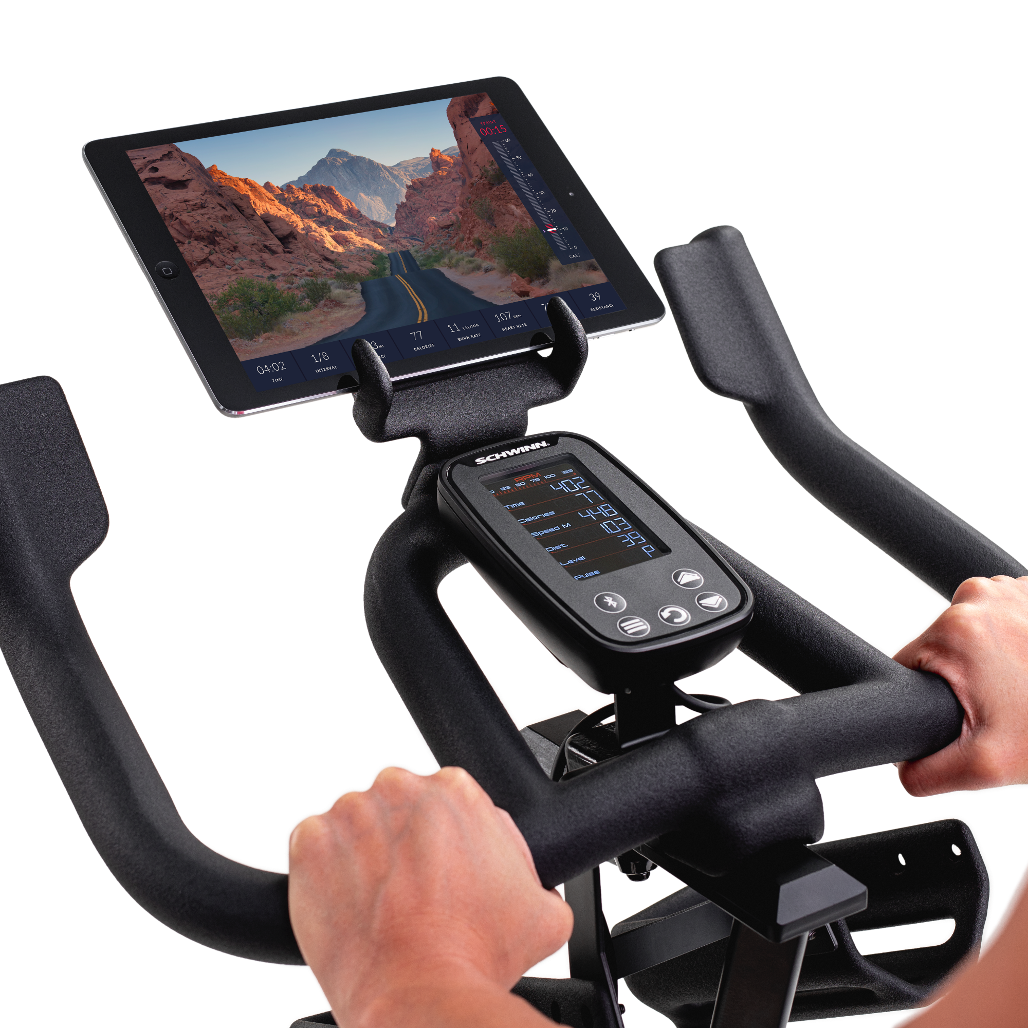 Schwinn IC4 console and a tablet showing a canyon road route above it